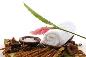 Obraz na płótnie Canvas salts in bowl ginger flower on towel and pile of cinnamon