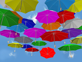 Multicolored umbrellas falling from the sky  clouds joy