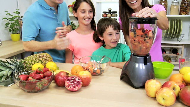 Health Conscious Parents Making Children Organic Fruit Drink