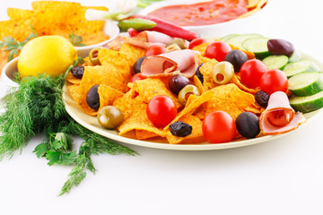 Nachos, olives, pork loin and vegetables