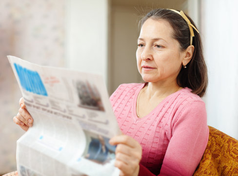 Mature Woman Reading Newspaper