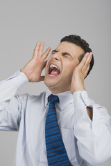 Businessman shouting with eye closed