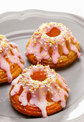 Traditional easter yeast cake covered with pink icing and colorf