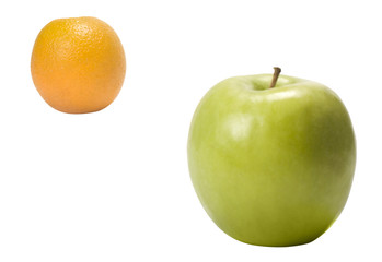 Close-up of an orange and a green apple