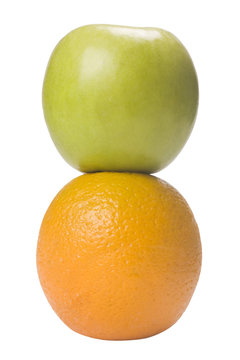 Close-up of an orange and a green apple