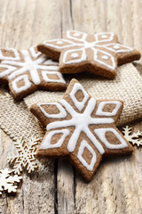 Fototapeta na wymiar Christmas gingerbread cookies in star shape on rustic wood