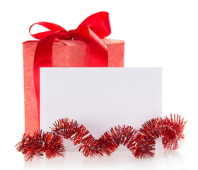 Bright gift box, tinsel and the empty card, isolated on white