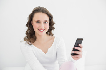 Fototapeta premium Smiling young woman with mobile phone