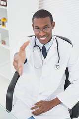 Doctor offering a handshake at medical office