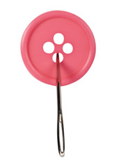 Close-up of a needle in the button hole