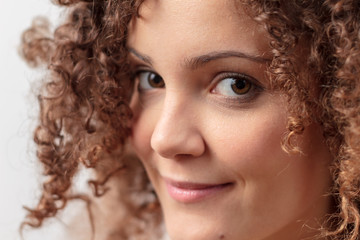 Beautiful young woman smiling, gorgeous curly hair