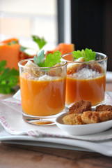 two glasses with pumpkin soup and bread