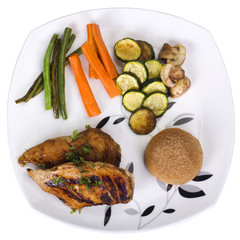 Chicken breast with bread and vegetables on a plate