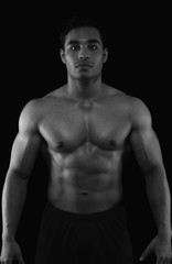 Fototapeta na wymiar Portrait of a muscular man showing his abs