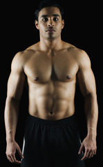 Fototapeta na wymiar Portrait of a muscular man showing his abs