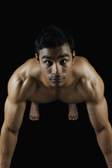 Fototapeta premium Portrait of a muscular man doing push-ups