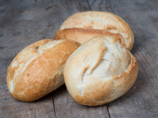 Rolls on the background of the wooden table 
