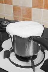 Milk boiling over a pan