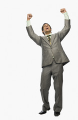 Businessman clenching fists in excitement