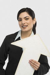 Businesswoman holding an upward arrow sign