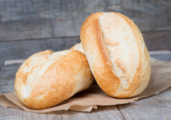 Rolls on the background of the wooden table 