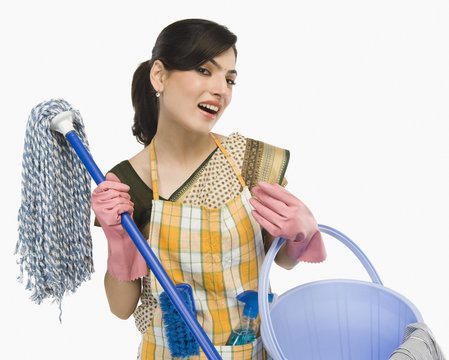 Woman holding a mop and a bucket