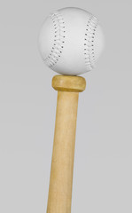 Baseball balancing on the top of a bat handle