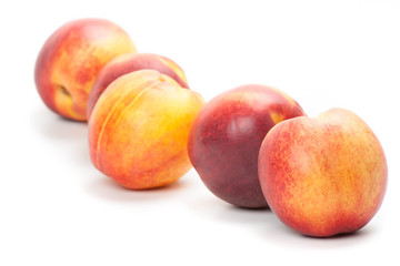 Ripe peaches fruits isolated on white