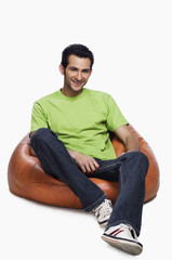 Portrait of a man sitting on a bean bag and smiling