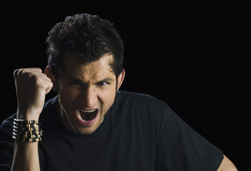 Portrait of a man clenching his fist and shouting