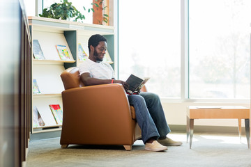 Student Reading Book In Bookstore