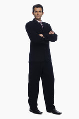 Obraz na płótnie Canvas Portrait of a businessman standing with his arms crossed