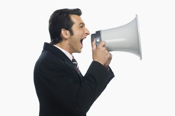 Businessman shouting into a megaphone