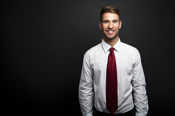 Profile portrait of a smiling and confident young businessman, w