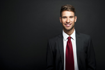 Businessman standing on dark gradient background