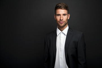 Businessman standing on dark gradient background