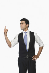 Businessman pointing upwards