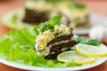 Liver cake with garlic and dill sauce on a plate