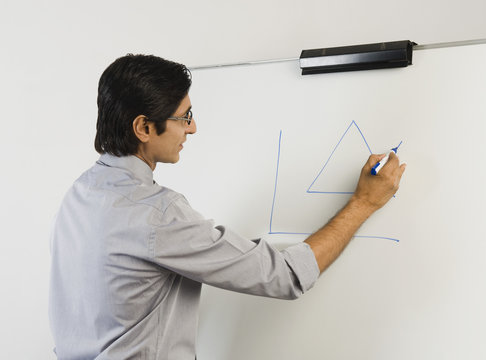 Teacher Writing On A Whiteboard