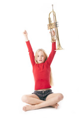 young girl in red holding trumpet in the air