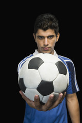 Soccer player showing a soccer ball
