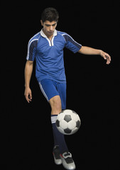 Soccer player practicing with a soccer ball
