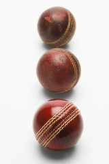 Obraz premium Close-up of old and new cricket balls in a row