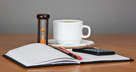 Open notepad and cup of coffee
