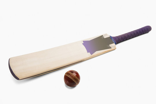 Close-up of a cricket ball with a bat