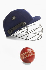 Naklejka premium Close-up of a cricket ball and a helmet