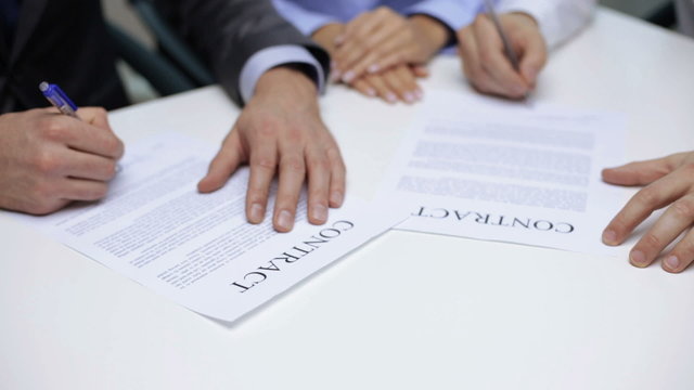 businessmen signing a contract