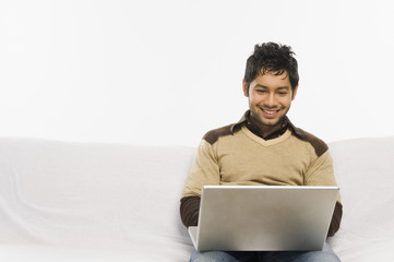 Man working on a laptop and smiling
