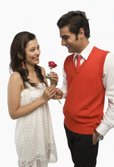 Man giving a rose to his girlfriend