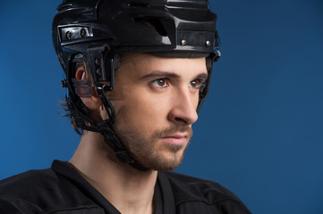 Handsome hockey player looking away.